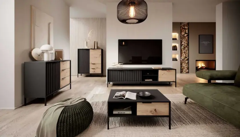 Nowoczesny salon z meblami w kolorze dąb Wotan, czerni i zieleni. Wygodna sofa, stolik kawowy i komoda tworzą przytulną przestrzeń.